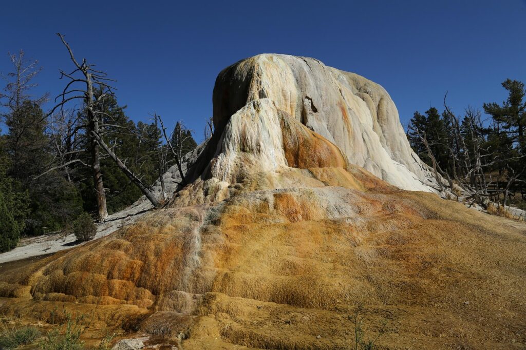 Orange travertine mound of a hot spring formation in Yellowstone